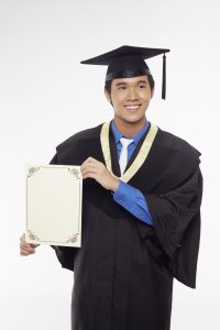 man-in-graduation-robe-holding-blank-certificate