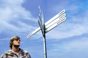 man-standing-under-a-signboard